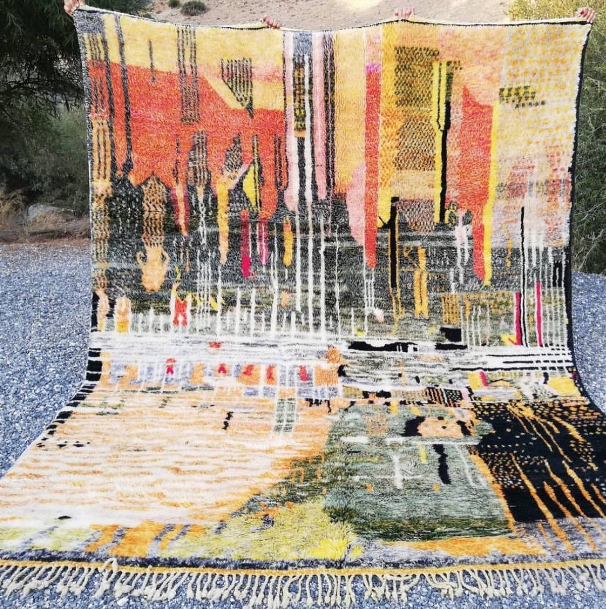 Detail close-up highlighting the textured surface and colorful patterns of the Moroccan rug.