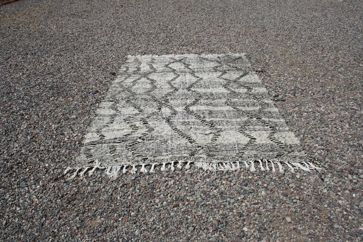 Front view of the gray and white Moroccan kilim rug featuring an intricate design.