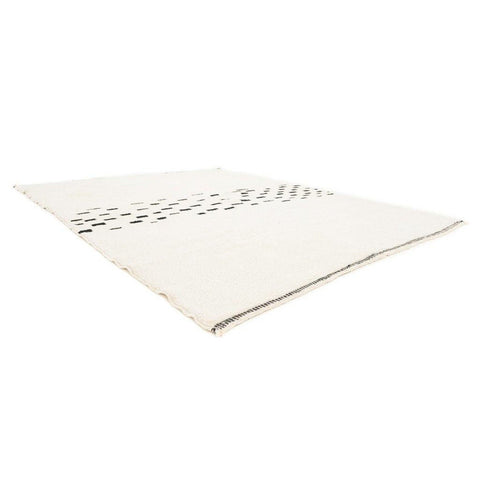 Side view of the cream and gray Moroccan area rug with Berber design.