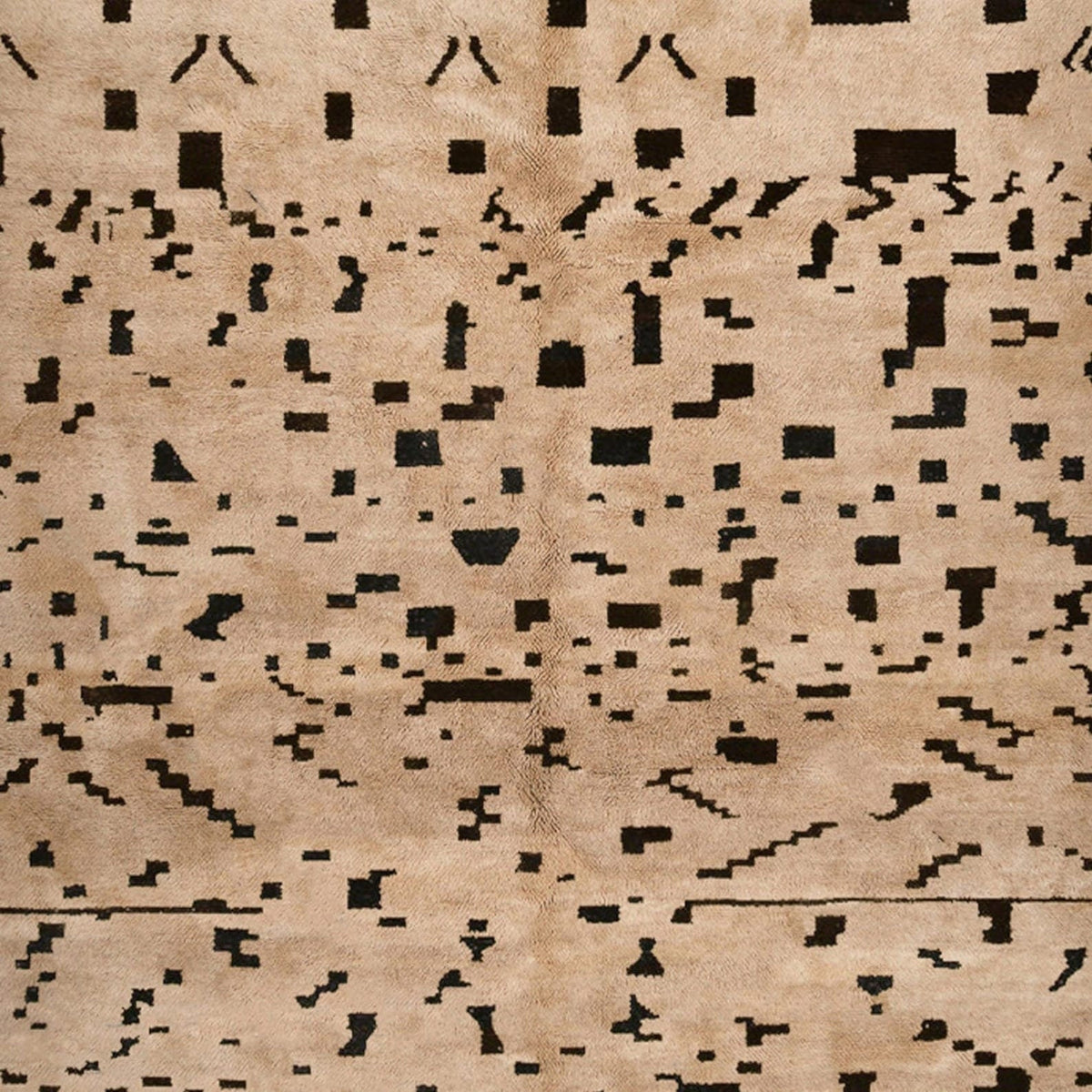 Side angle of the tan speckled Moroccan rug highlighting its abstract design.