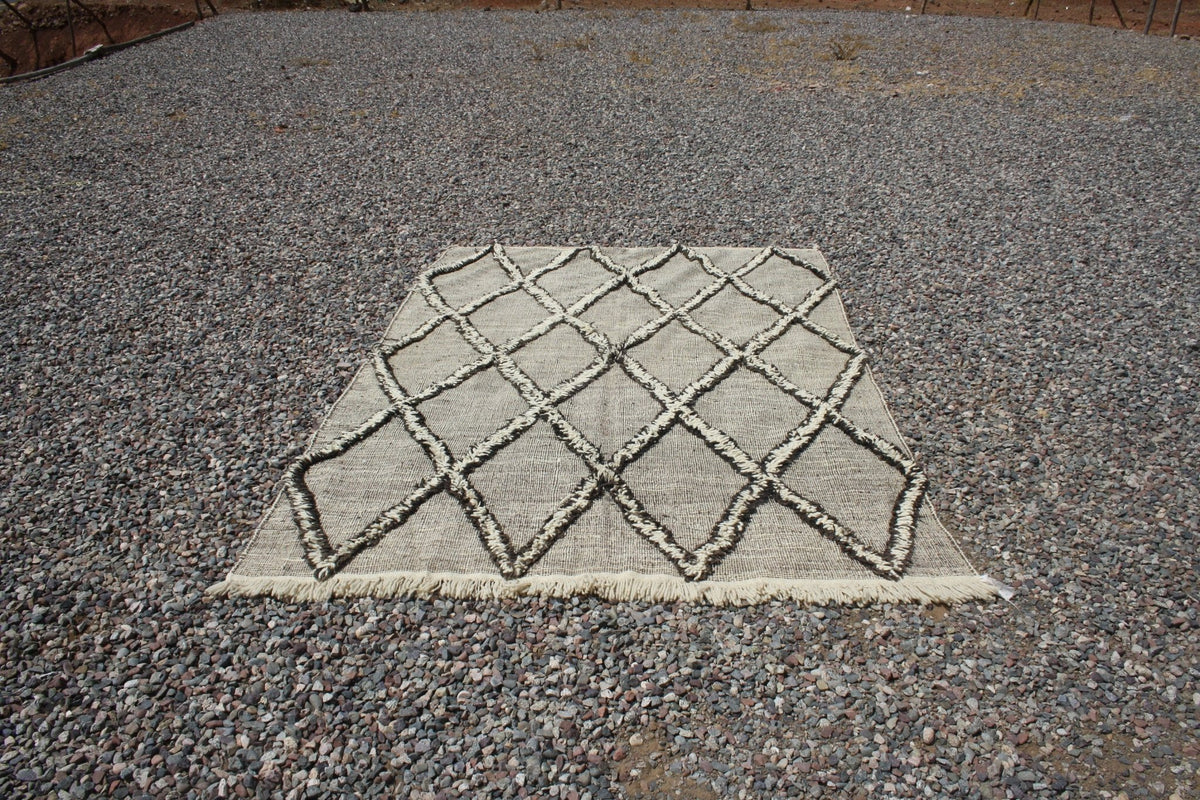 Lifestyle view of a textured surface Moroccan kilim rug in beige and brown tones.