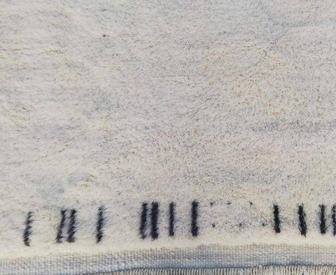 Detail close-up of the abstract Moroccan rug showcasing its textured surface and patterned design.