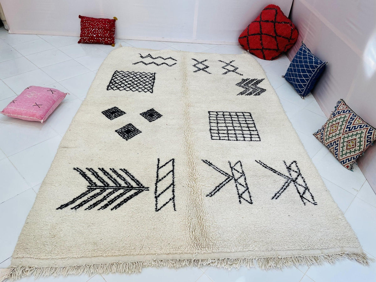 Lifestyle view of a cream and black geometric Beni Ourain Moroccan rug showcasing abstract patterns.