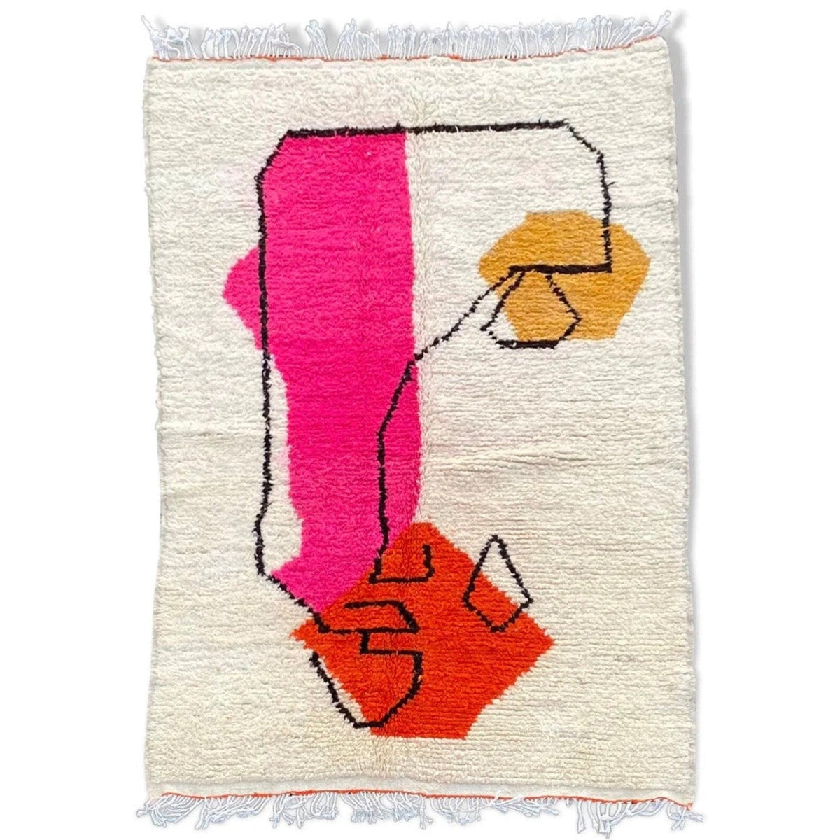 Detail shot of a pink and orange geometric pattern on a Beni Ourain rug.