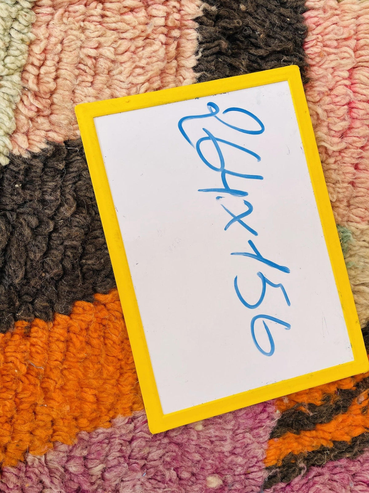 Detail view of a vintage Moroccan rug showcasing an abstract design with vibrant colors.