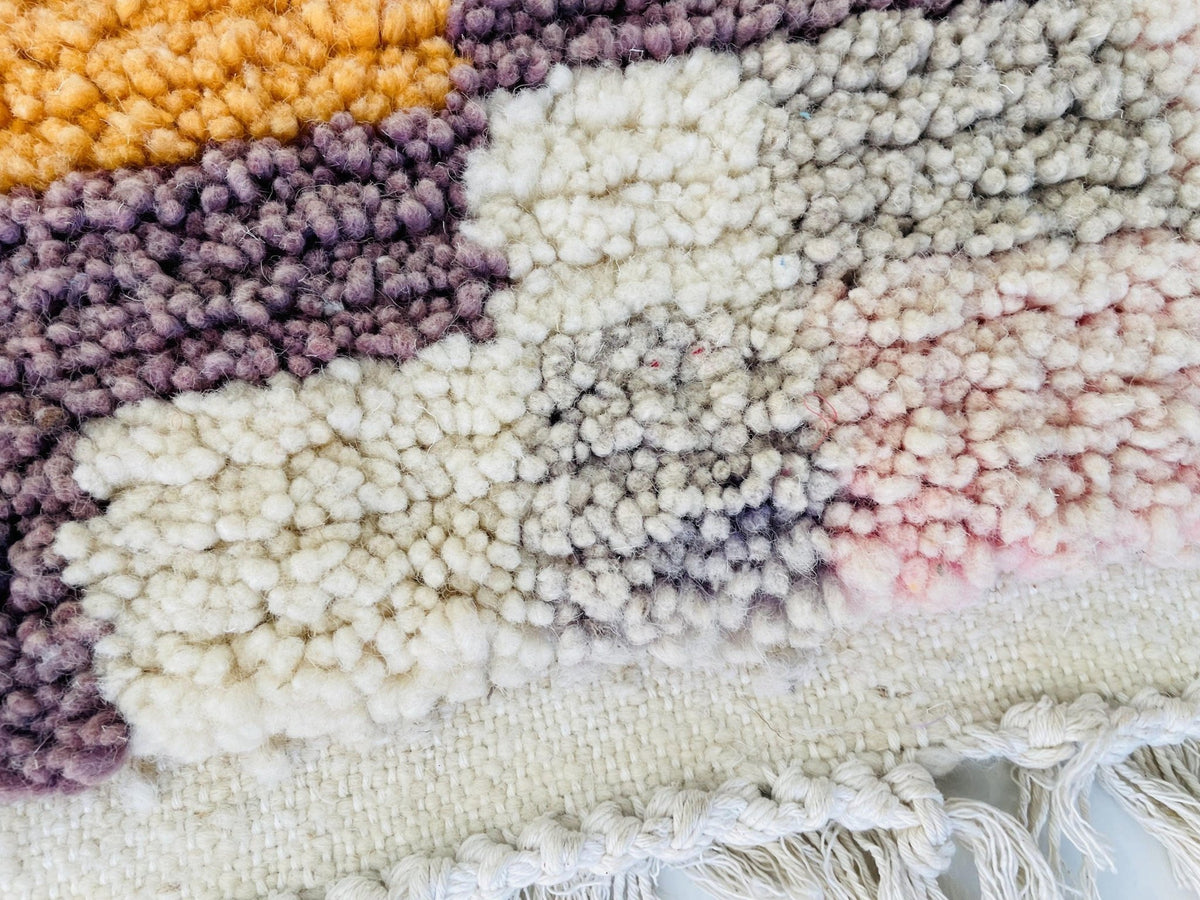 Lifestyle shot of a geometric patterned runner rug in a studio environment.