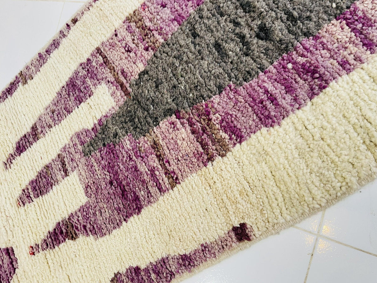 Close-up of the rug edge highlighting the fringe detail against a white background.
