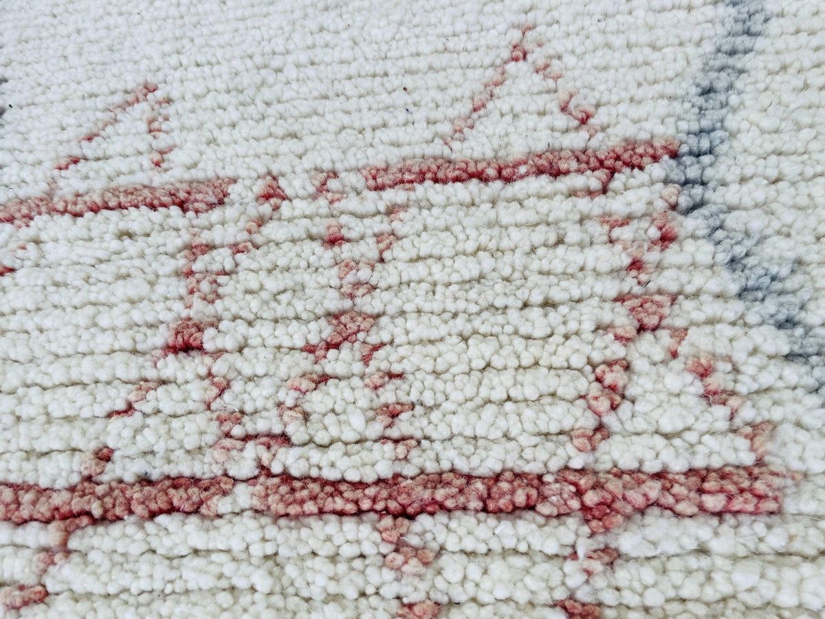 Close-up detail of the geometric design and thick weave of the rug.