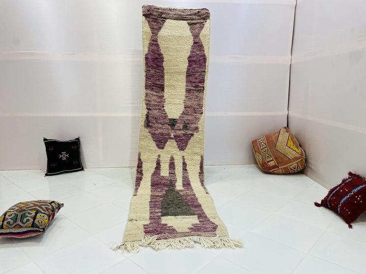 Lifestyle shot of the cream geometric vintage Moroccan runner rug in a studio setting.