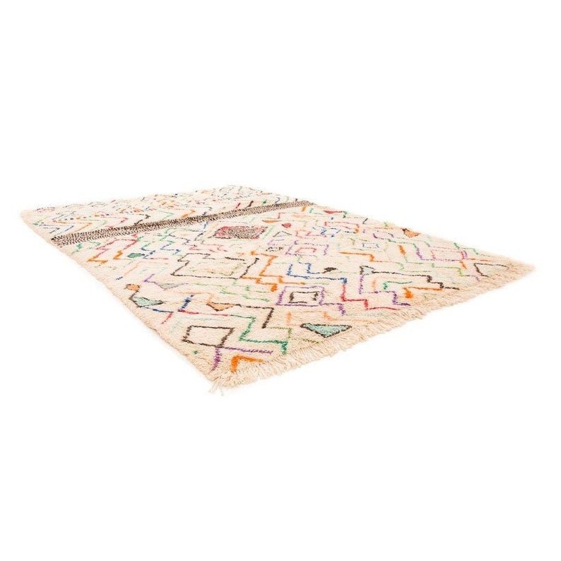 Lifestyle shot of a multicolor Moroccan rug with geometric patterns and a soft texture in a natural setting.