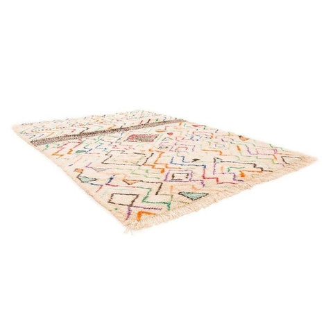 Lifestyle shot of a multicolor Moroccan rug with geometric patterns and a soft texture in a natural setting.
