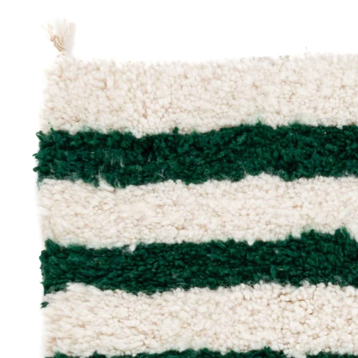 Detail shot highlighting the soft texture and fringe edge of the Azilal Moroccan rug in white and green.