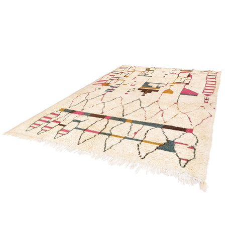 Detail close-up of a textured surface with tribal designs in a Moroccan rug featuring beige, red, black, and yellow.