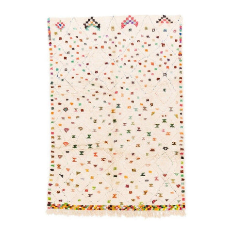 Front view of a cream pastel dotted Moroccan rug with polka dot pattern and fringed edges.
