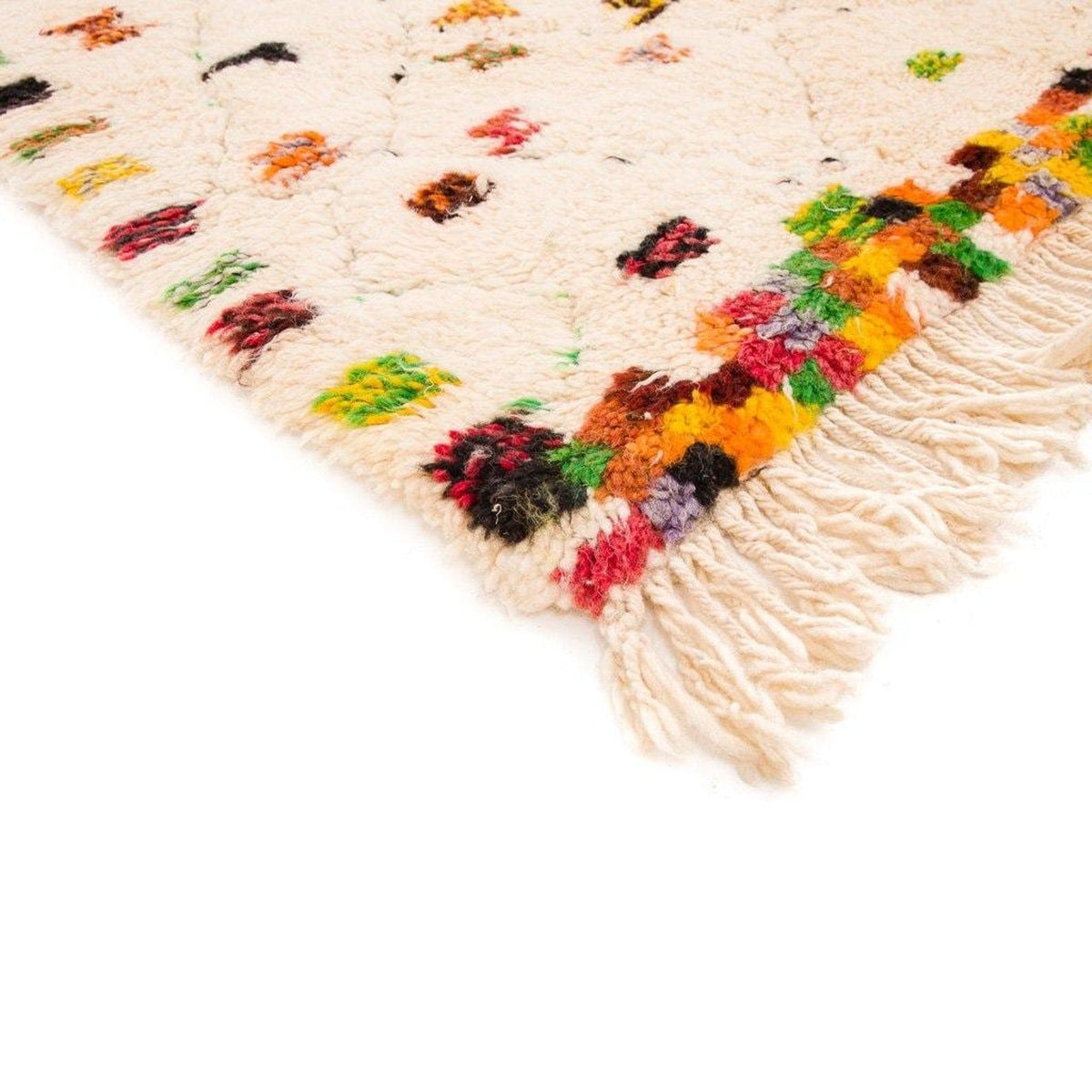 Close-up detail of a cream pastel dotted Moroccan rug showcasing its polka dot pattern.