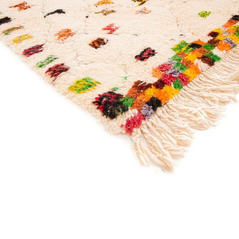 Close-up detail of a cream pastel dotted Moroccan rug showcasing its polka dot pattern.
