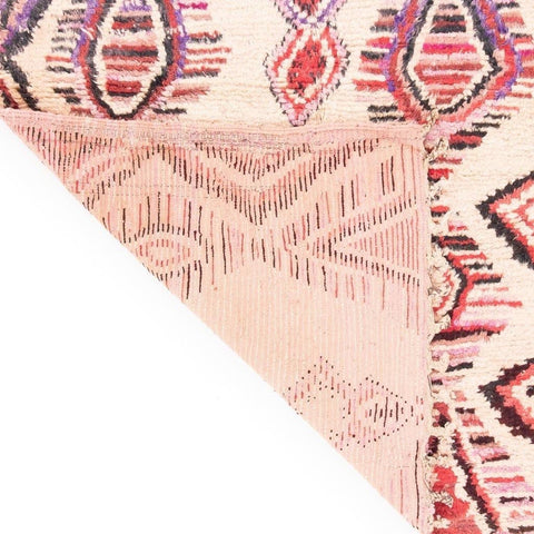 Detail view of the corner of the Azilal rug highlighting geometric patterns and textured fabric.