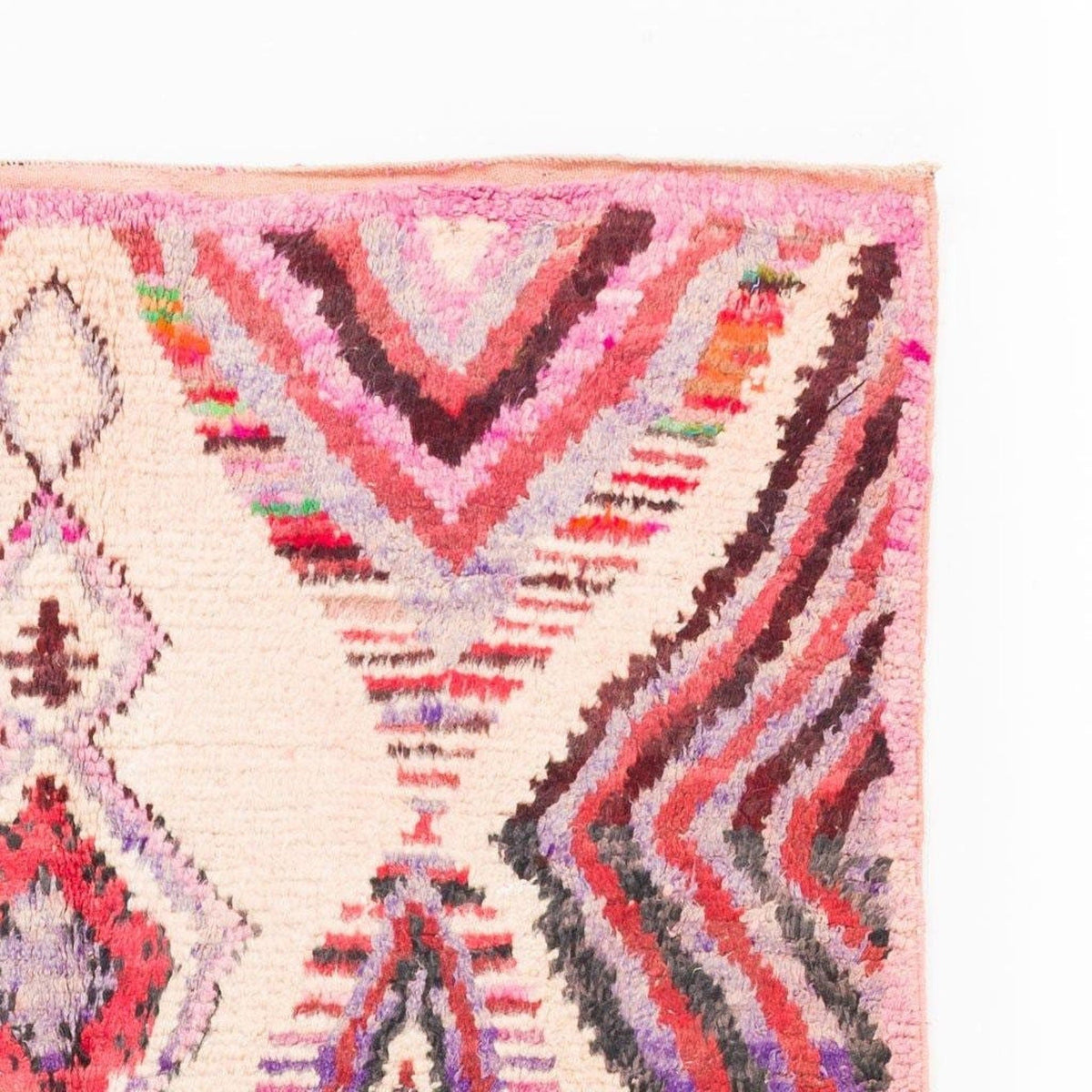 Detail shot of the Azilal rug featuring diamond shapes and colorful accents.