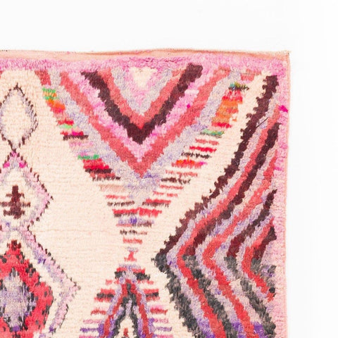 Detail shot of the Azilal rug featuring diamond shapes and colorful accents.