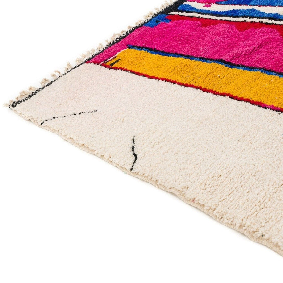 Side view of the Azilal Moroccan rug displaying vibrant tribal patterns in pink and blue.