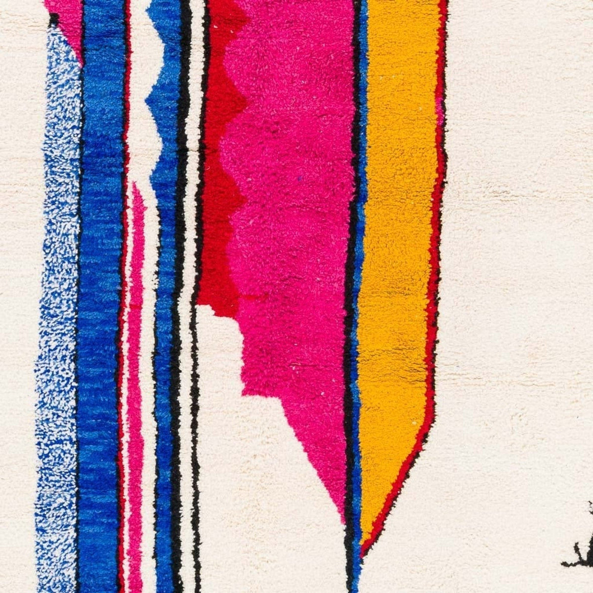 Close-up detail of colorful Azilal rug featuring tribal patterns and a soft texture.