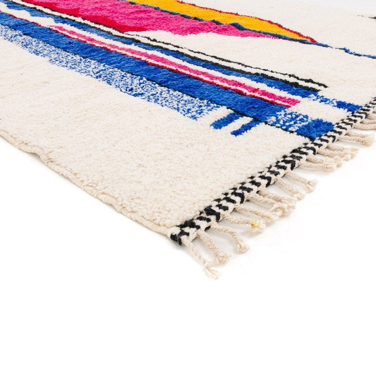 Close-up detail of the Azilal Moroccan rug highlighting tribal patterns in pink, blue, and yellow.