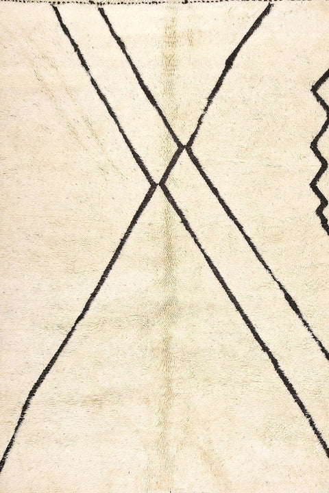 Close-up detail of the fringe on the cream geometric line rug in off-white.