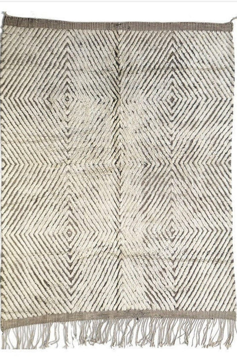 Front view of the soft gray textured Moroccan rug featuring black and off-white colors with fringe edges.