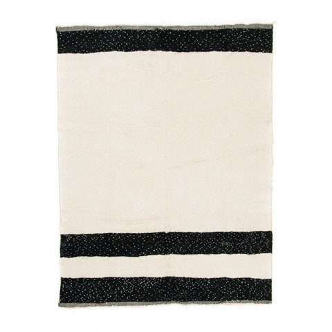 Front view of the black and cream striped Moroccan rug on a white background.