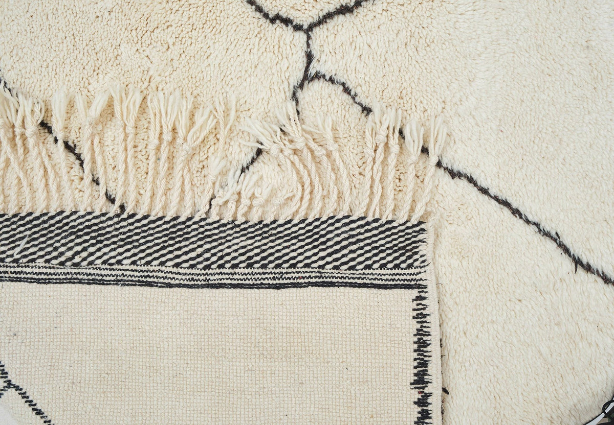 Close-up detail showing the textured fibers and geometric design of the rug.
