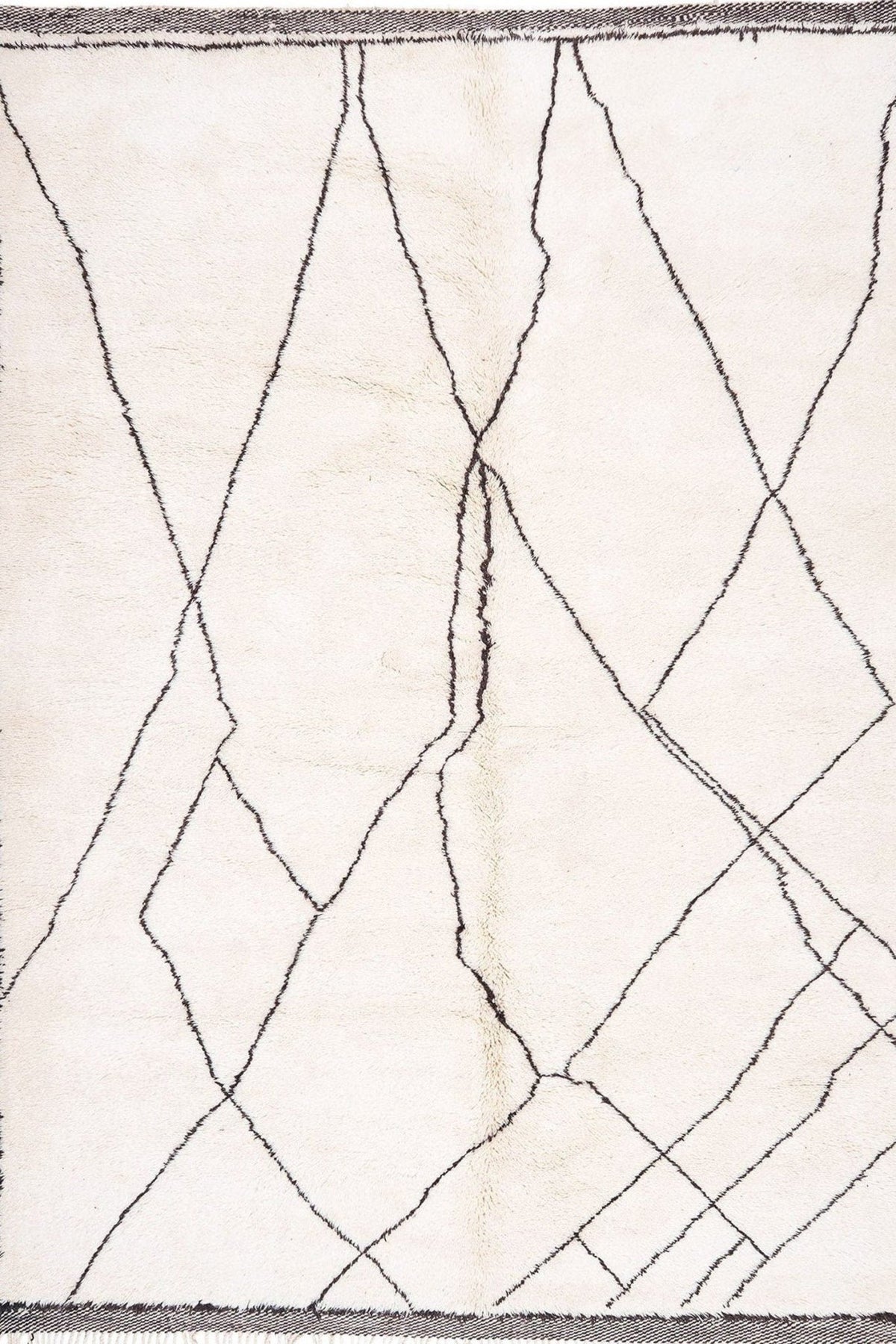 Close-up view of the textured pattern on the black and off-white rug.