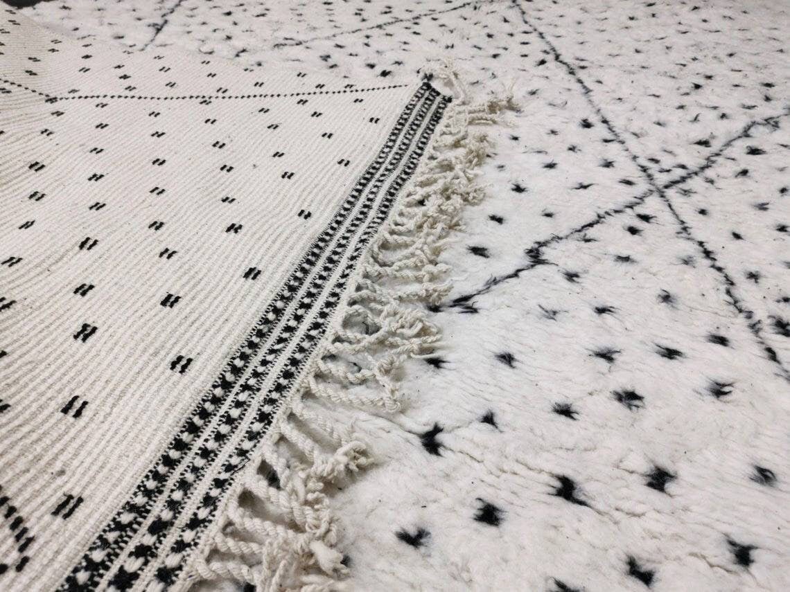 Close-up detail highlighting the fringe and patterned design of a Moroccan rug.