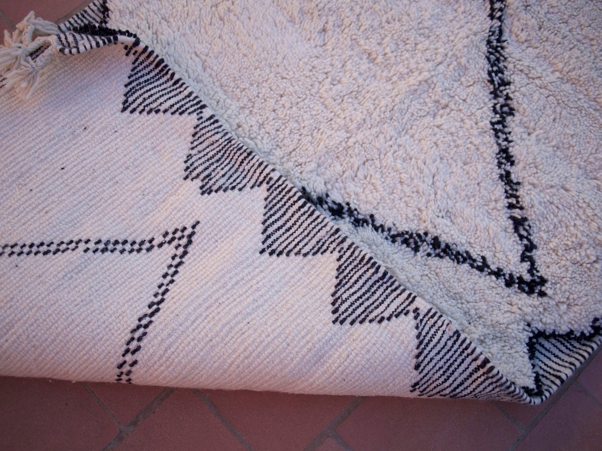 Detail close-up of the handwoven black and white geometric runner rug with a geometric pattern.