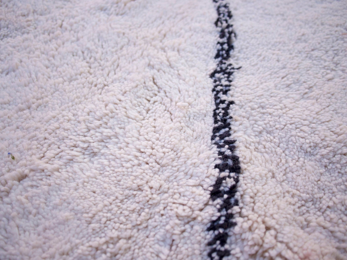 Detail close-up of the black and white geometric runner rug with a black line pattern.