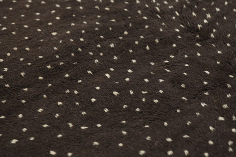 Close-up detail of the textured surface of the black and off-white Beni Ourain Moroccan rug.