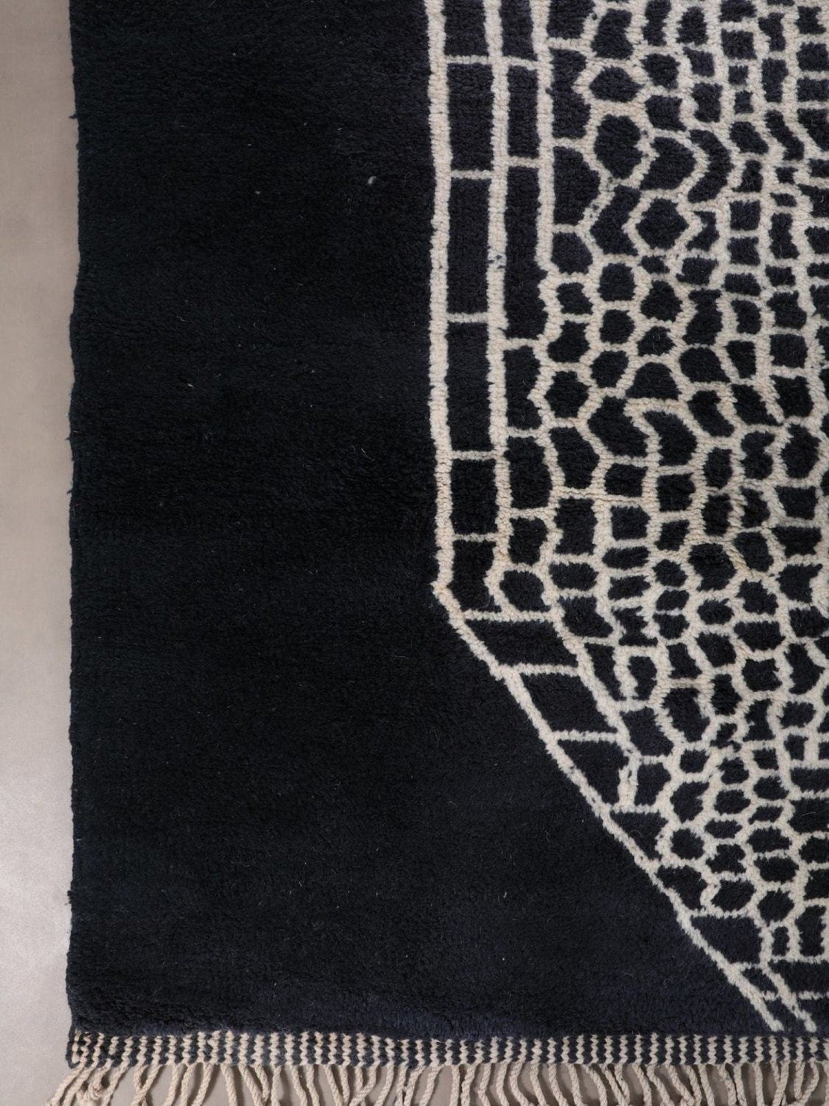 Detail shot of a black and white rug showing a textured surface and modern style.
