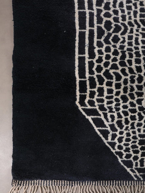 Detail shot of a black and white rug showing a textured surface and modern style.