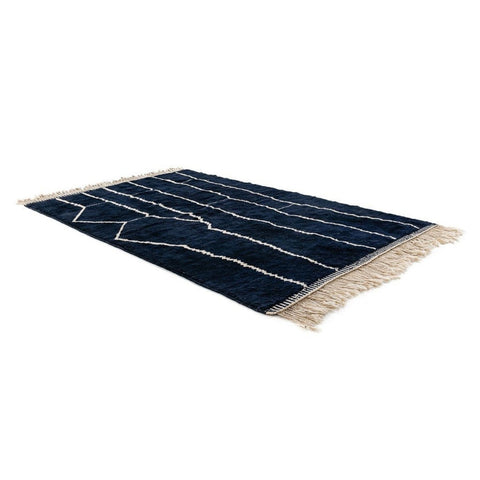 Lifestyle shot of a black and white abstract Beni Ourain Moroccan rug featuring a geometric design.