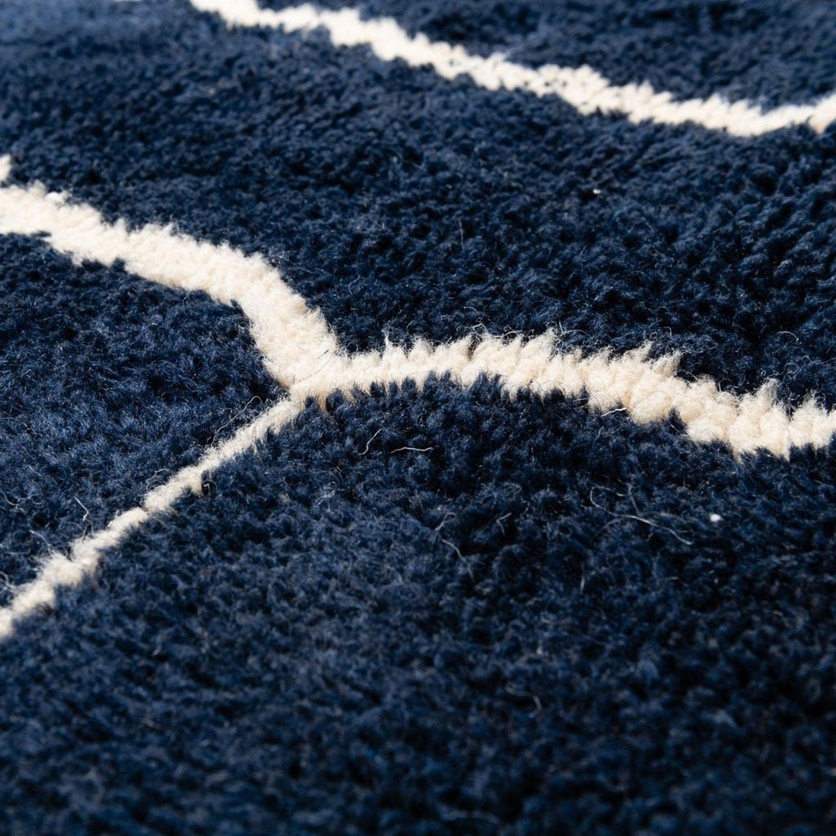 Detail view of a black and white abstract Beni Ourain Moroccan rug emphasizing its textured surface.