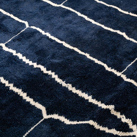 Detail shot of a black and white abstract Beni Ourain Moroccan rug with an abstract pattern.