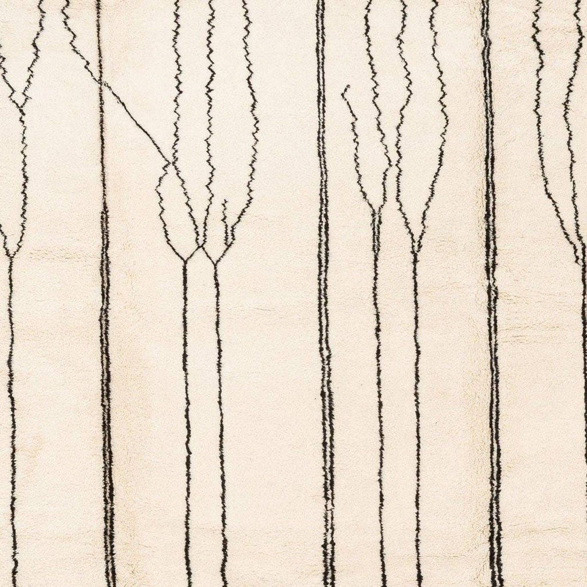 Close-up showing the geometric pattern and soft texture of the beige striped Moroccan rug.