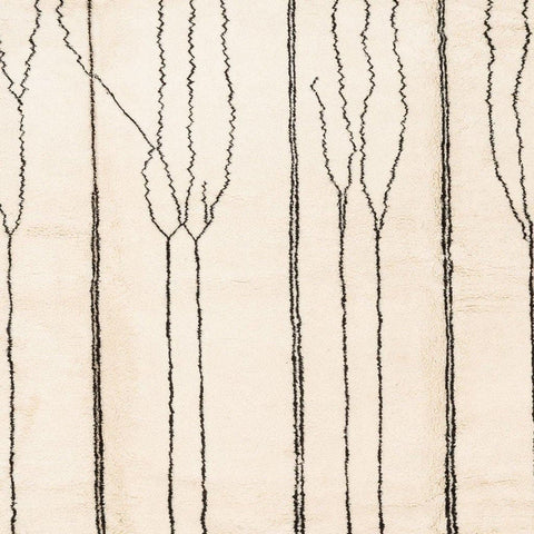 Close-up showing the geometric pattern and soft texture of the beige striped Moroccan rug.