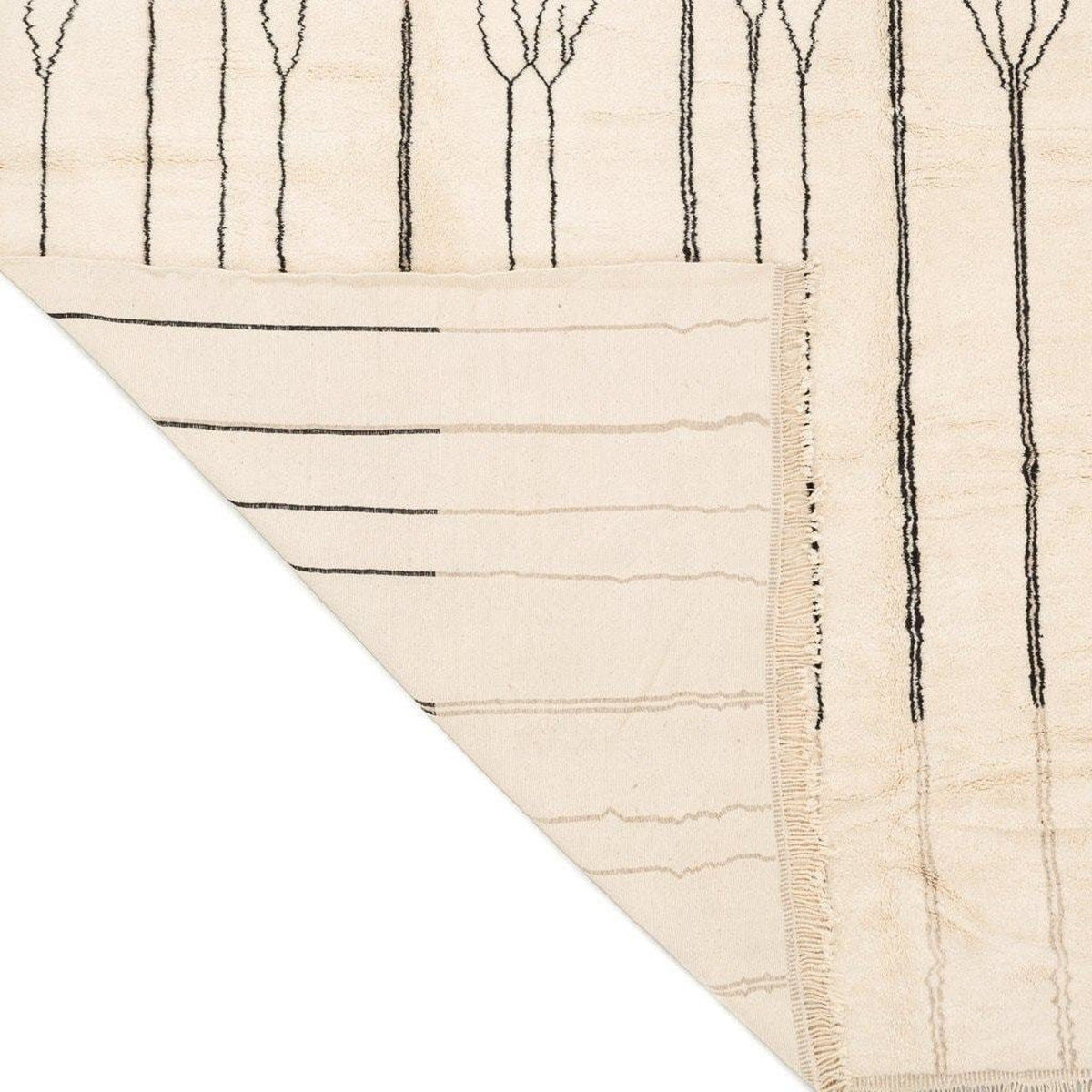 Detail of the geometric pattern on the beige striped Moroccan area rug.