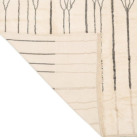 Detail of the geometric pattern on the beige striped Moroccan area rug.