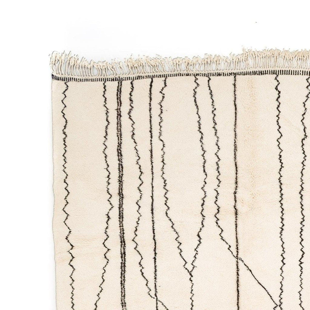 Detail of the Berber design on the beige striped Moroccan rug.