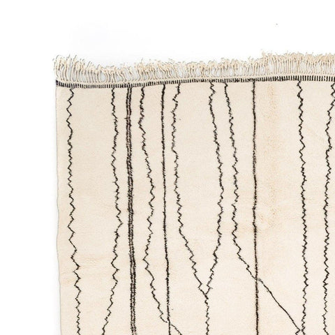 Detail of the Berber design on the beige striped Moroccan rug.