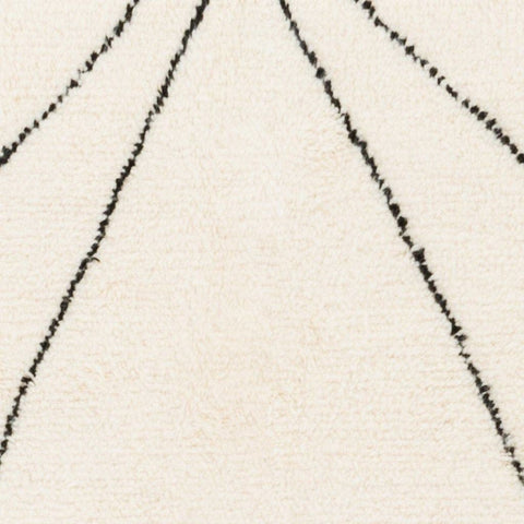 Close-up detail of the black and white Moroccan rug displaying line patterns and a soft texture.