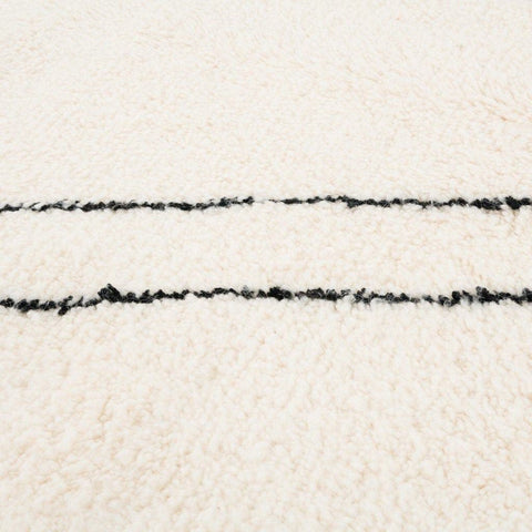 Close-up detail of the ivory diamond Moroccan area rug highlighting its thick pile and woven design.