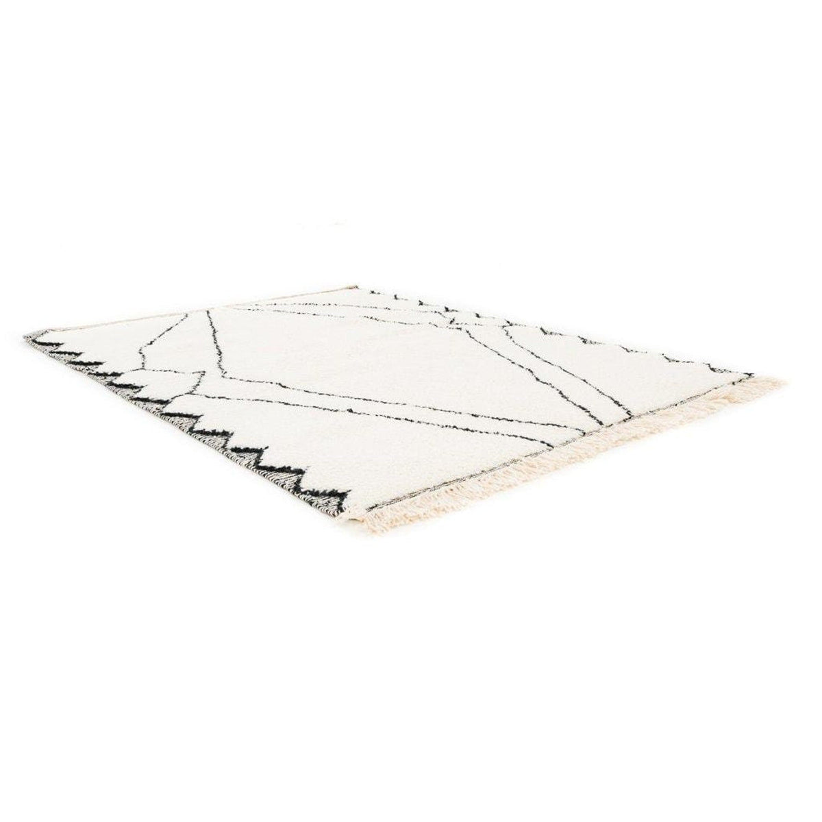 Close-up detail of the black and white Moroccan rug with a geometric pattern and soft texture.