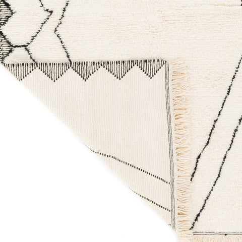 Close-up detail of the black and white Moroccan rug showcasing a zigzag design.
